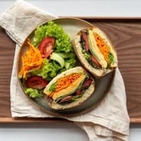 Lunch box with grilled chicken, rice, and salad